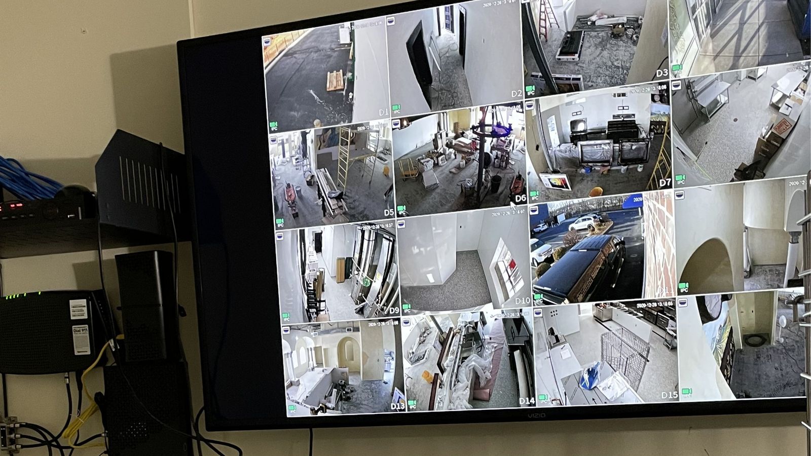 Security camera monitor wall showing live NVR feeds